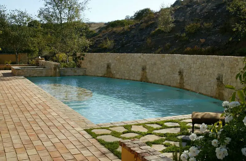 Mediterranean Pool With Stone Wall